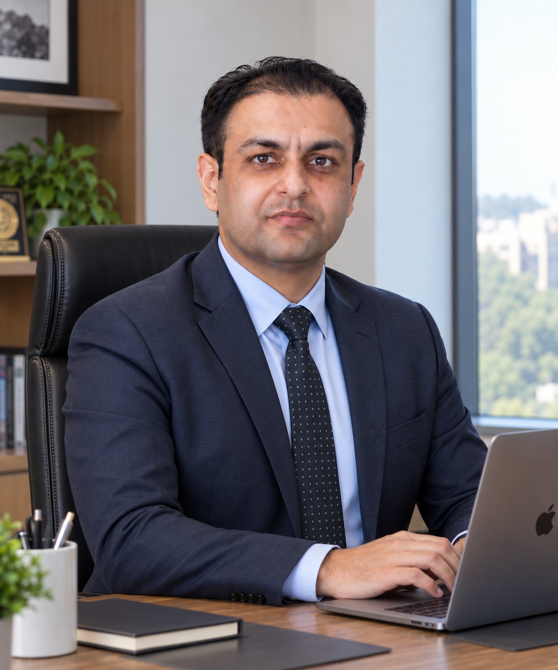 Dr. Muhammad Asif Ali seated in his office